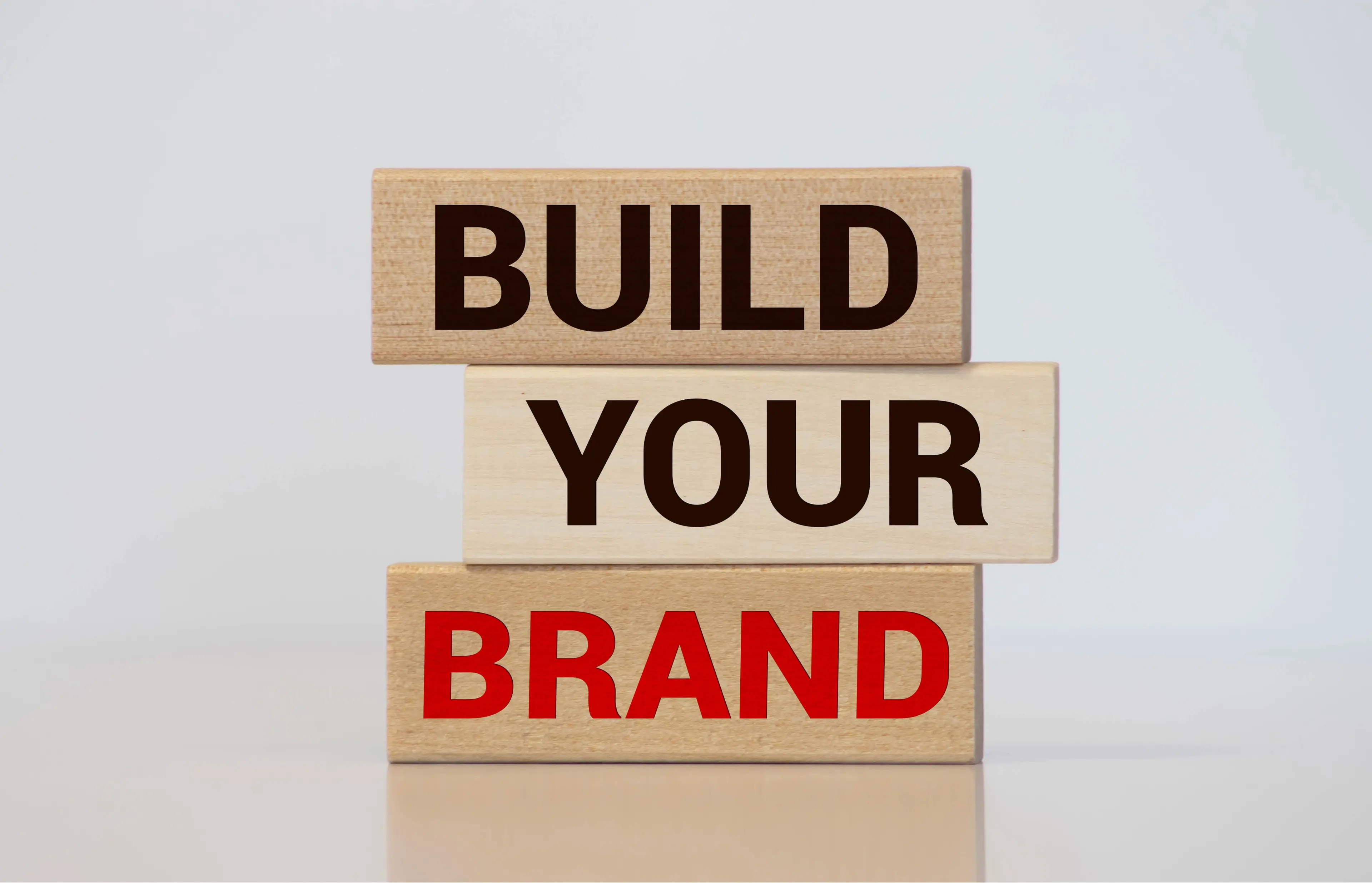 Wooden building blocks spelling build your brand