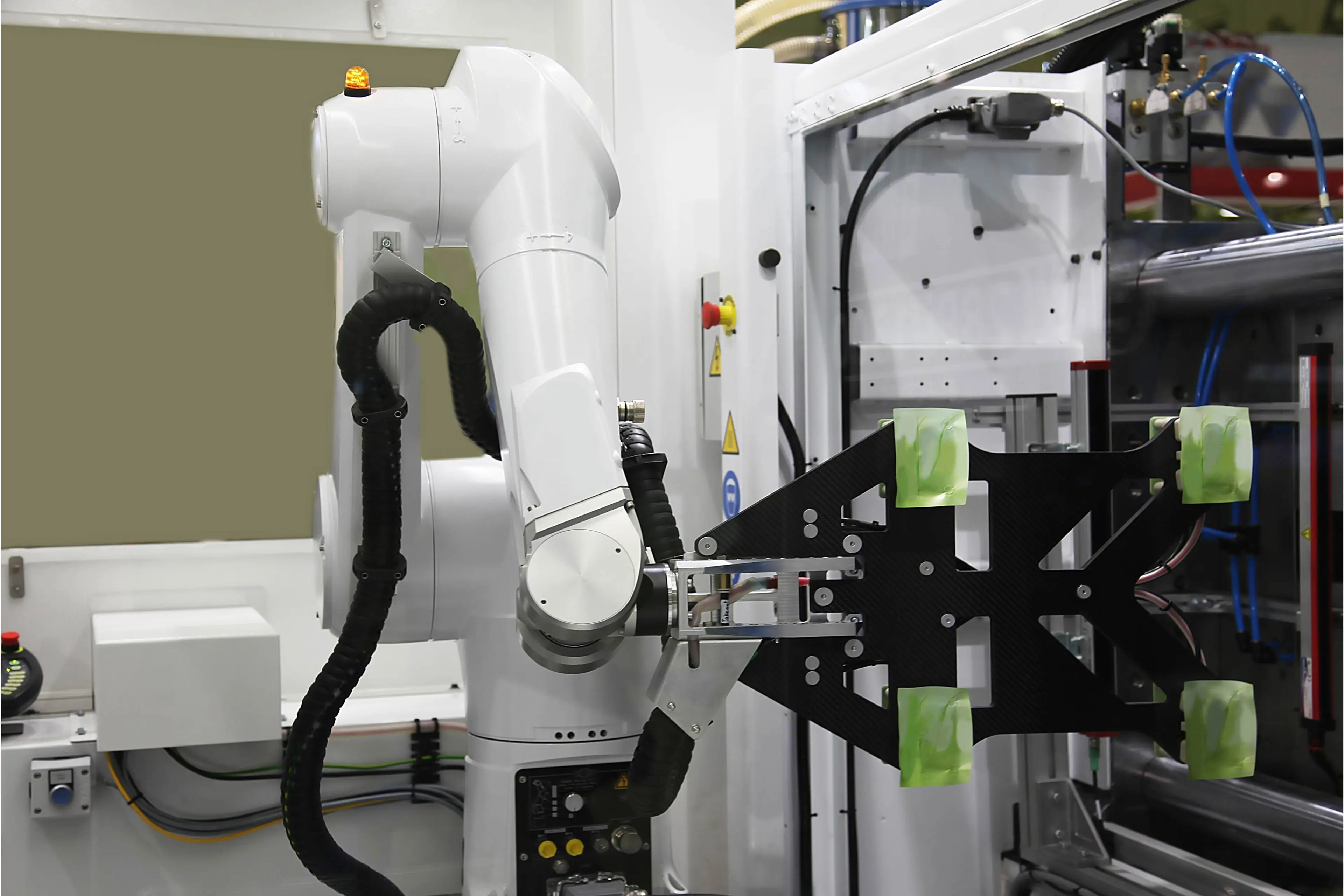 A robot performing injection molding in a factory.